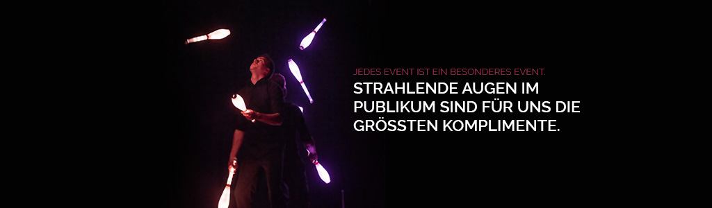 Daniel and Julius Juggling 6 LED clubs on stage back to back